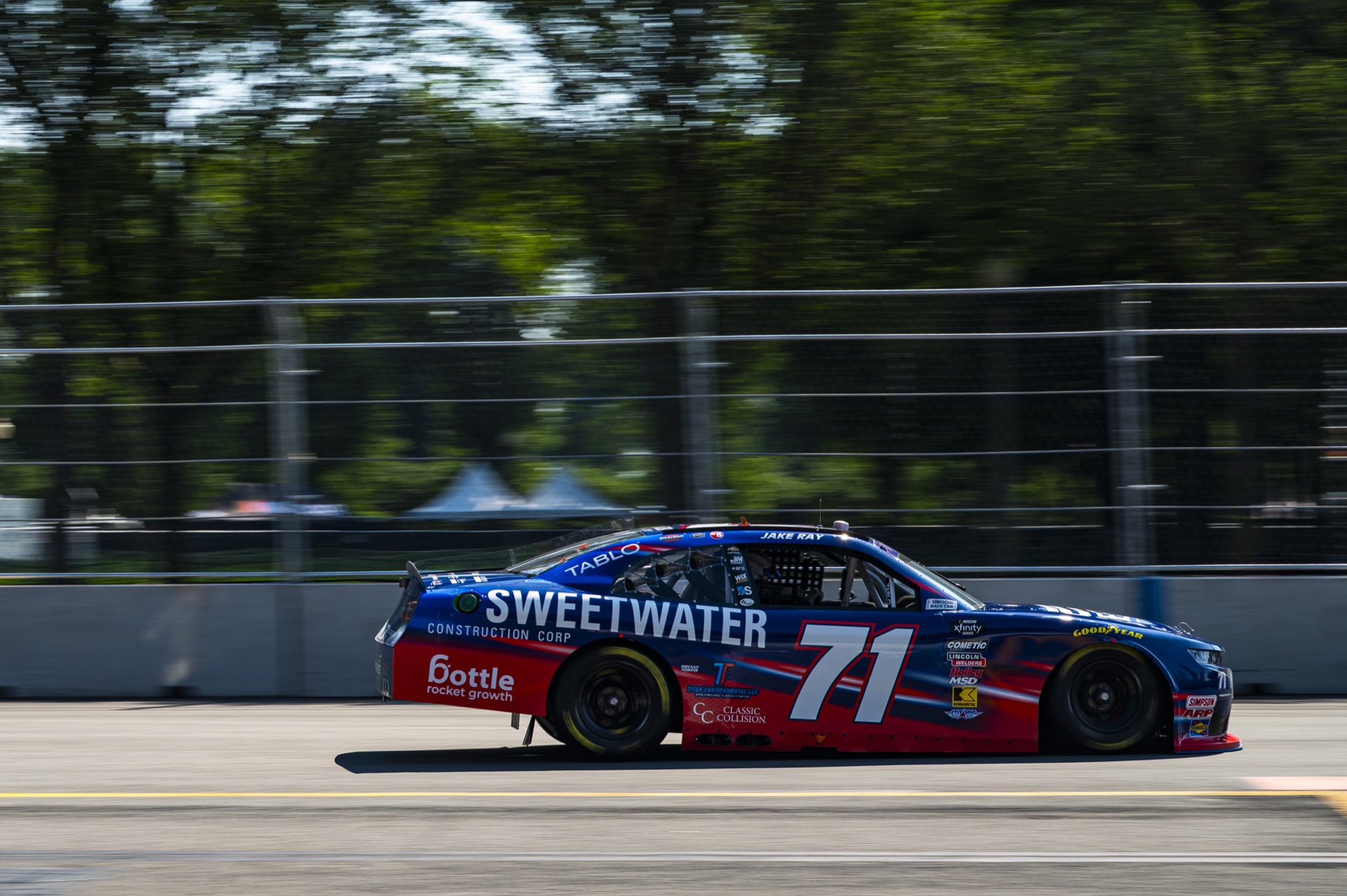 Bottle Rocket Growth logo on the rear quarter panel of the number 71 race car on track in Chicago